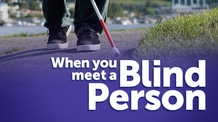 an image of a blind persons feet as they use a white cane to walk along a path with a purple overlay and the words 'When you meet a blind person'