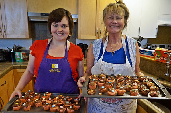 an image of two women holding baked goods