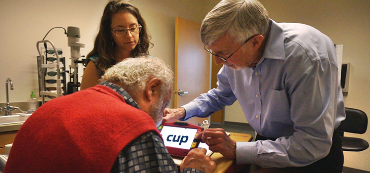 an image of a Dr. at Society For The Blind with a patient in the evaluation room