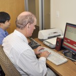 man typing at computer during assistive tech class