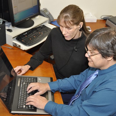student and mentor working with assistive tech