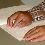 image of person reading braille