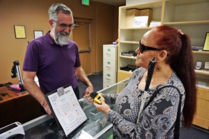 Shirley Garrett receives help from Cory Hanosh at the expanded onsite retail store at Society for the Blind in Sacramento.