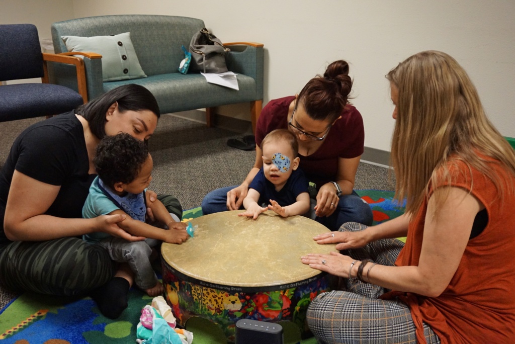 Toddler-Parent Group Engaging in a Drum Circle