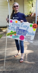NFC Participant Karon with a sign that says "Doing every little Fitbit possible"
