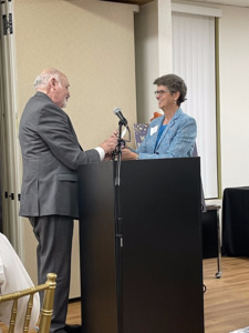 Dr. Mannis accepts the Briggs Award from Executive Director Shari Roeseler
