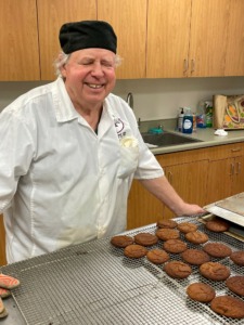 Dan O'Connor poses with a tray of freshly baked cookies