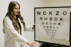 Dr. Edwards prepares eye chart for an exam