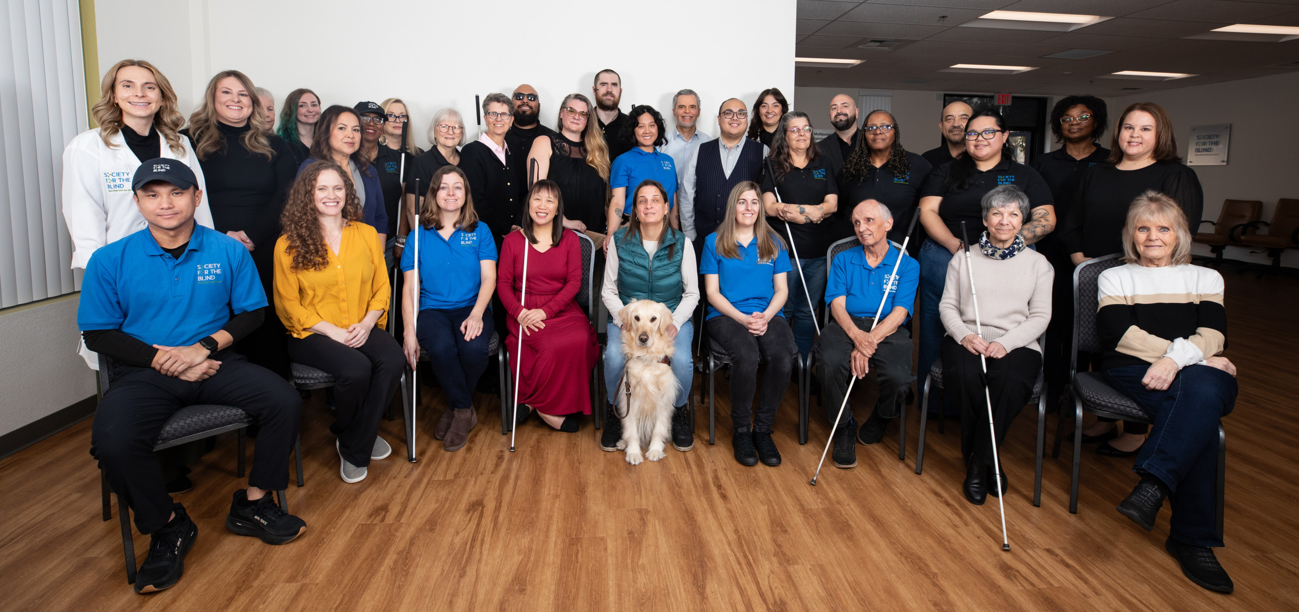 An image of the Society for the Blind team posting for a photograph